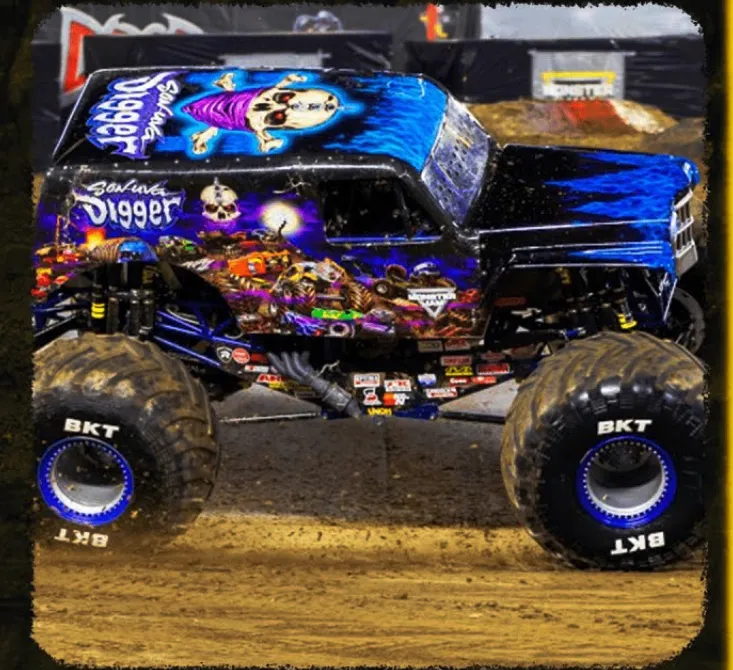 A monster truck driving on a dirt track