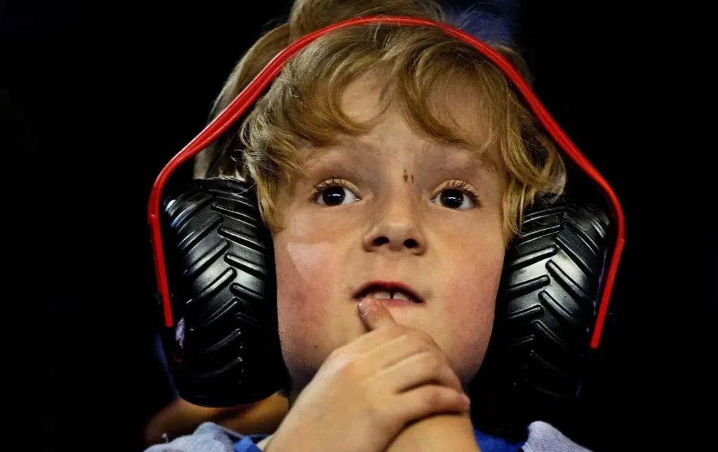 Families wearing hearing protection while entering crowded Ball Arena event.