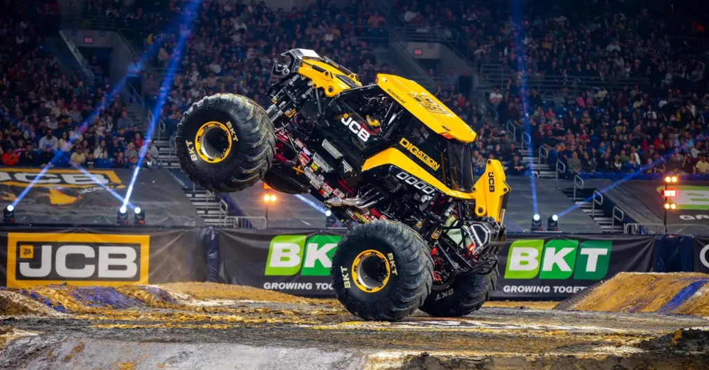 JCB DIGatron and Grave Digger performing precision monster truck stunt challenges.