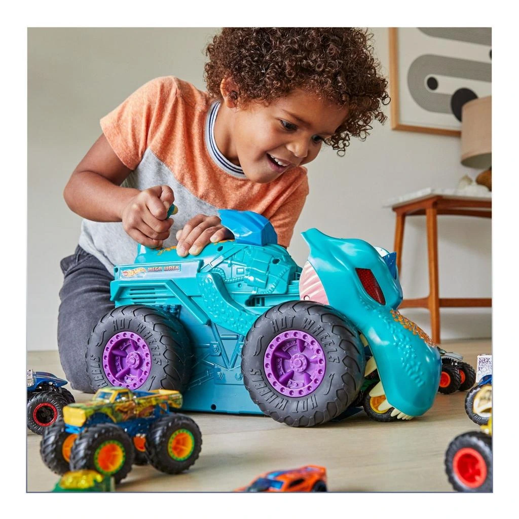 Children exploring giant monster trucks during Hot Wheels pre-show party.