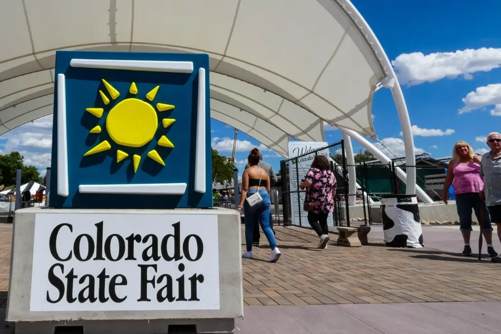 Visitors entering Colorado State Fair grandstand for monster truck weekend events.